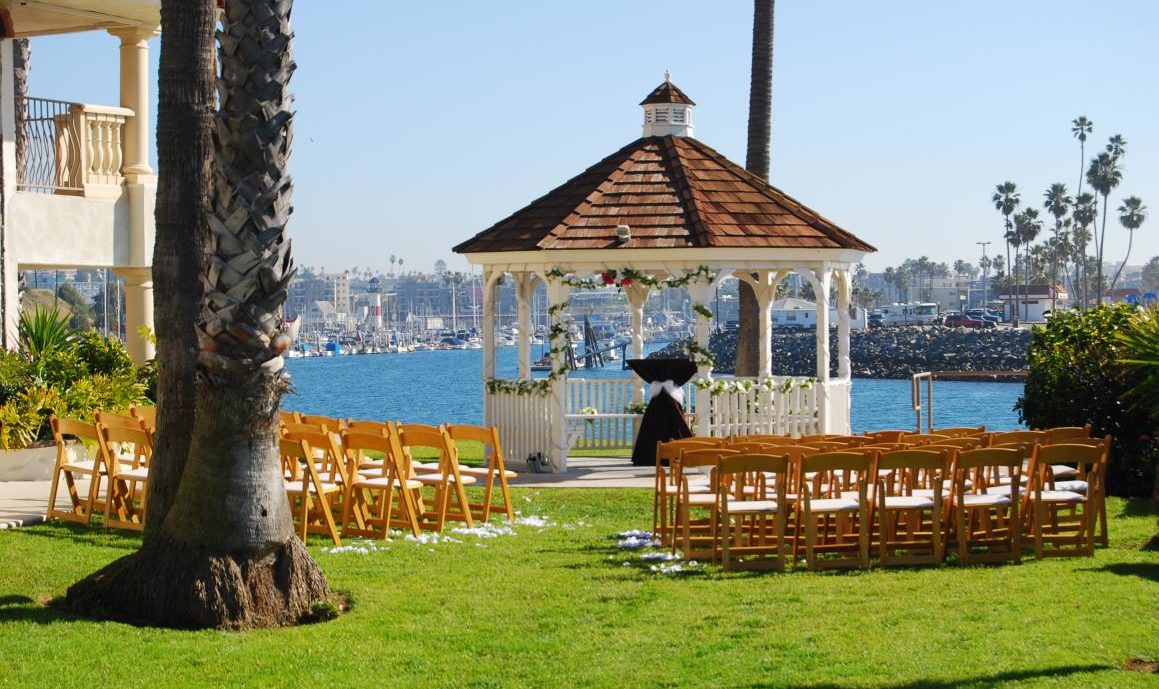 Outdoor Gazebo overlooking the Pacific Ocean with wooden chairs set up for a wedding ceremony